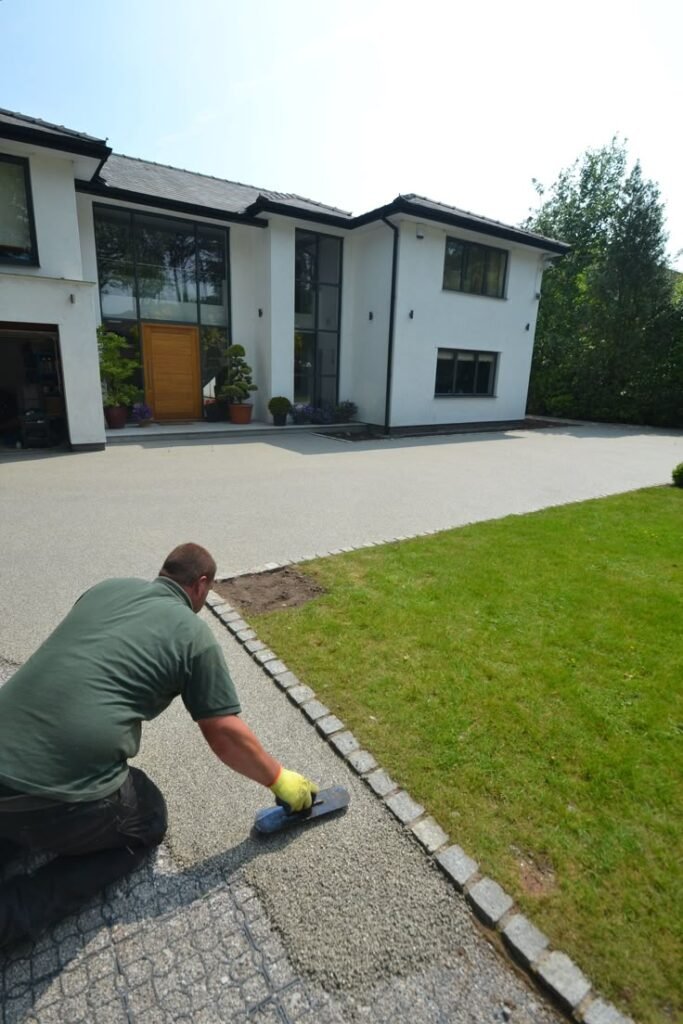 Resin-bound driveway installation in progress, showing professional application of durable resin surface.
