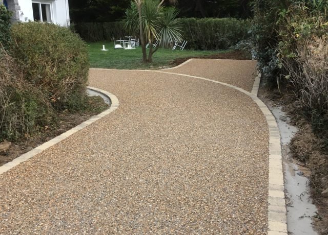 Well-designed gravel driveway with smooth surface and neatly edged borders, enhancing curb appeal.