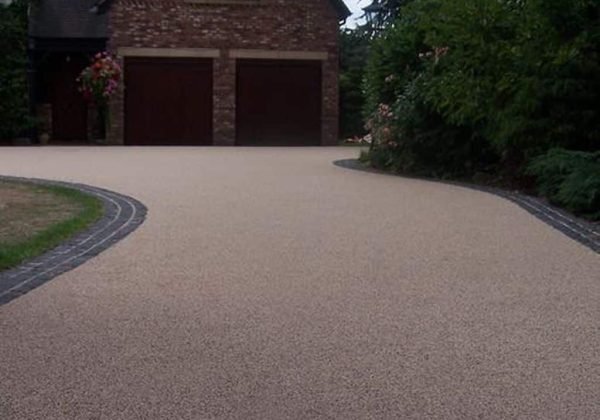 Beautifully installed resin-bound driveway with a smooth finish and a neat border, enhancing curb appeal.