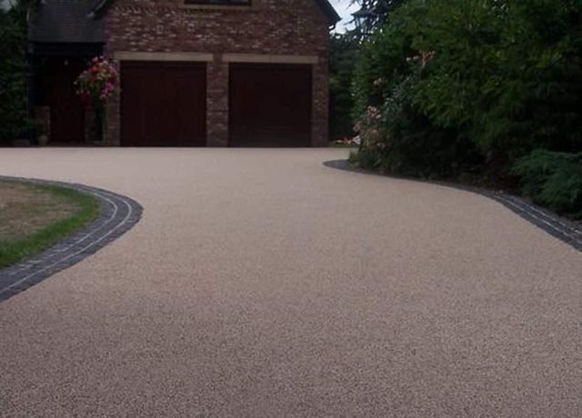 Beautifully installed resin-bound driveway with a smooth finish and a neat border, enhancing curb appeal.