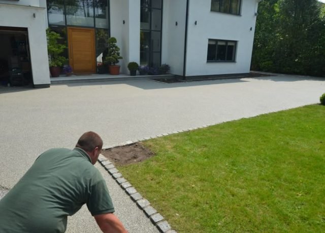 Resin-bound driveway installation in progress, showing professional application of durable resin surface.